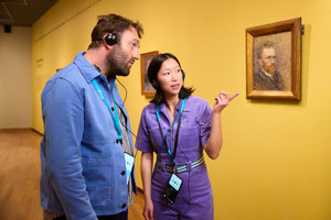 Two visitors listen to the audio tour at the Van Gogh Museum in front of a self-portrait by Vincent van Gogh. Photo: Suzanne Karsters