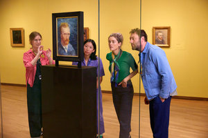 A group of visitors look at a painting painted on the back of a self-portrait of Vincent van Gogh at the Van Gogh Museum during a guided tour. Photo: Suzanne Karsters