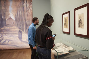 Two visitors are looking at Van Gogh's drawings in The Potato Eaters exhibition. Photo: Maaike Koning